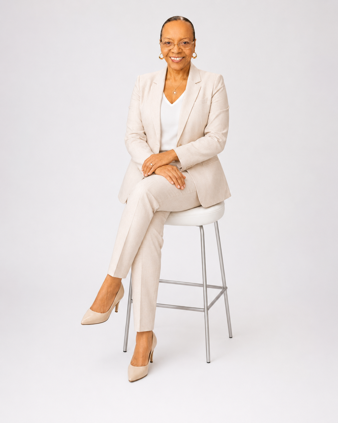 Irene Coleman, founder of IreneTeachesAI, seated in a cream suit